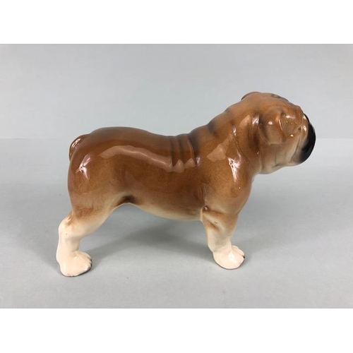 127 - Ceramic Bulldogs, four bulldog figures of varying size, one with Coppercraft trade label to base, on... 