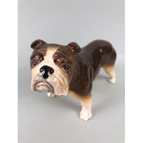 127 - Ceramic Bulldogs, four bulldog figures of varying size, one with Coppercraft trade label to base, on... 