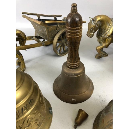 131 - Vintage Brass ware, to include a pair of heavy horses pulling carts and Four bells, (the larger with... 