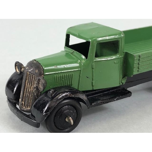 141 - Dinky Toys, 25A Bedford flat bed lorry in green with black hub caps and grill