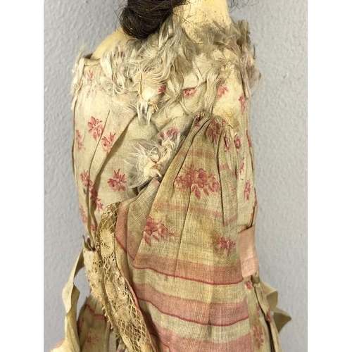 142 - Antique doll, early 19th Century wood and cloth bodied doll with painted gesso face, silk clothes wi... 