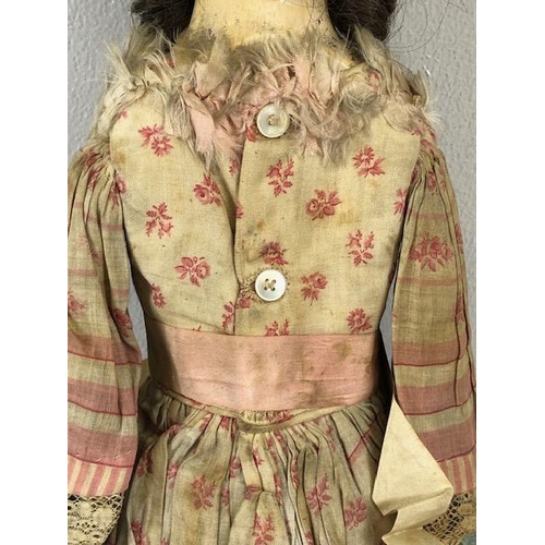 142 - Antique doll, early 19th Century wood and cloth bodied doll with painted gesso face, silk clothes wi... 