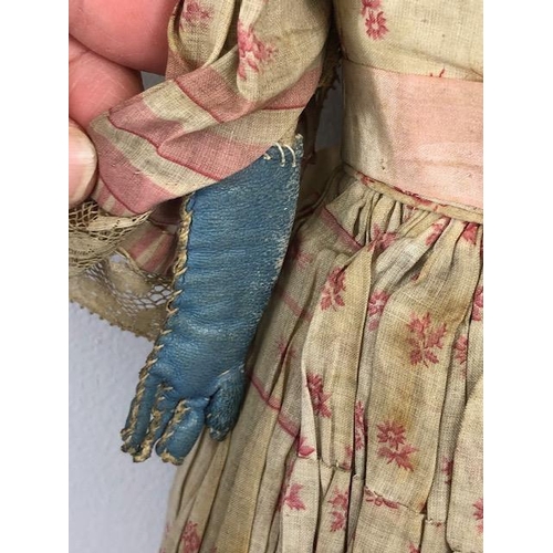 142 - Antique doll, early 19th Century wood and cloth bodied doll with painted gesso face, silk clothes wi... 