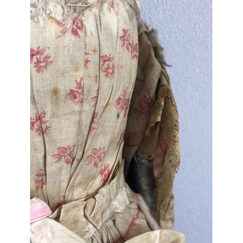 142 - Antique doll, early 19th Century wood and cloth bodied doll with painted gesso face, silk clothes wi... 