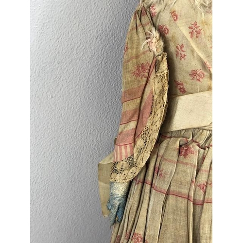 142 - Antique doll, early 19th Century wood and cloth bodied doll with painted gesso face, silk clothes wi... 