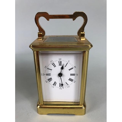 174 - Vintage carriage clock of brass with clear panels, white dial with roman numerals approximately 11cm... 