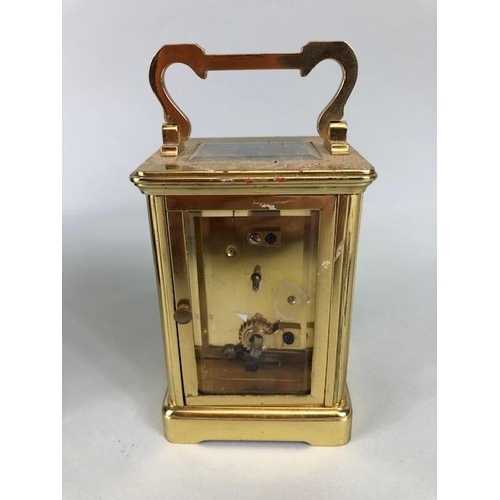 174 - Vintage carriage clock of brass with clear panels, white dial with roman numerals approximately 11cm... 