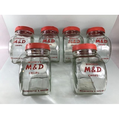 181 - Advertising interest, early 20th century Meredith & Drew glass shop storage jars with red composite ... 