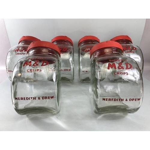 181 - Advertising interest, early 20th century Meredith & Drew glass shop storage jars with red composite ... 