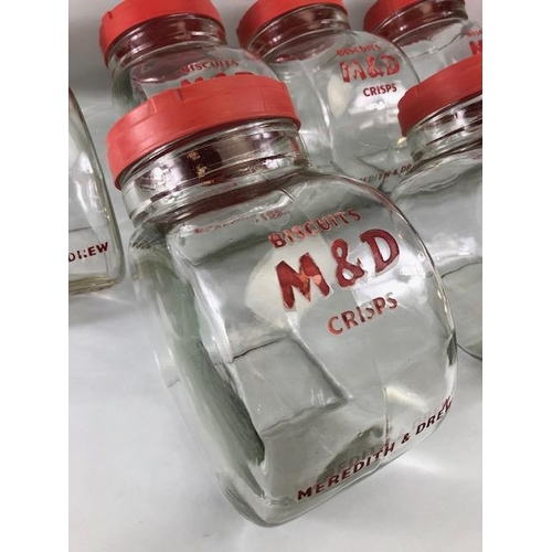 181 - Advertising interest, early 20th century Meredith & Drew glass shop storage jars with red composite ... 