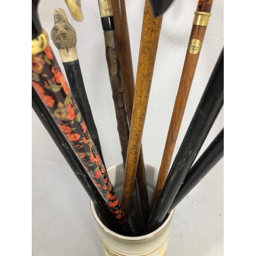 188 - Collection of walking sticks in a ceramic stick stand , various designs, faux amber, faux bone, horn... 