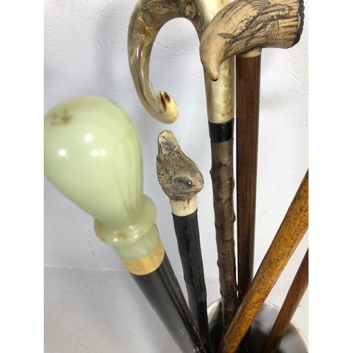 188 - Collection of walking sticks in a ceramic stick stand , various designs, faux amber, faux bone, horn... 