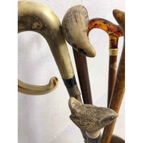 188 - Collection of walking sticks in a ceramic stick stand , various designs, faux amber, faux bone, horn... 