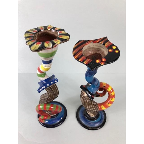 209 - Ross Emerson Art ceramics, being Two twisty candle sticks  in multi colour ways approximately 24 and... 