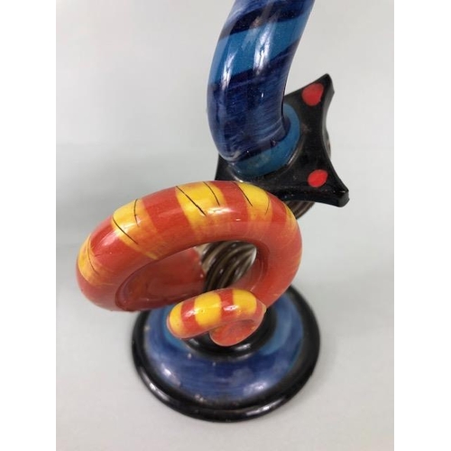 209 - Ross Emerson Art ceramics, being Two twisty candle sticks  in multi colour ways approximately 24 and... 