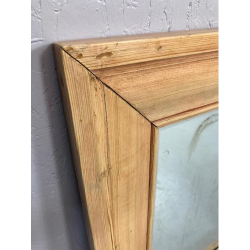 214 - Antique bevel edged mirror in a wide stripped Pine frame approximately 55 x 65cm