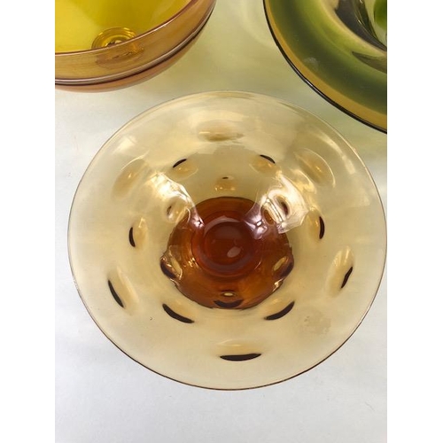 245 - Art Studio glass, Three amber glass bowls all with ground bases one with a signature