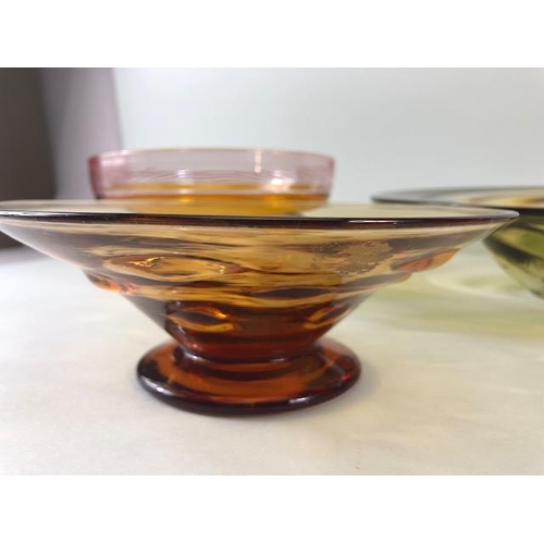 245 - Art Studio glass, Three amber glass bowls all with ground bases one with a signature