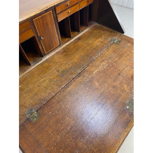 316 - Oak Bureau with four drawers, fall front revealing pigeon holes and ornate key to lock