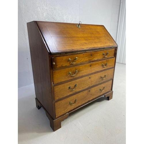 316 - Oak Bureau with four drawers, fall front revealing pigeon holes and ornate key to lock