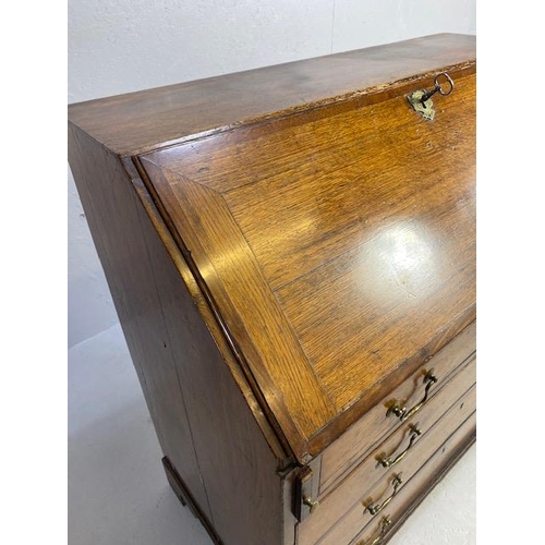 316 - Oak Bureau with four drawers, fall front revealing pigeon holes and ornate key to lock