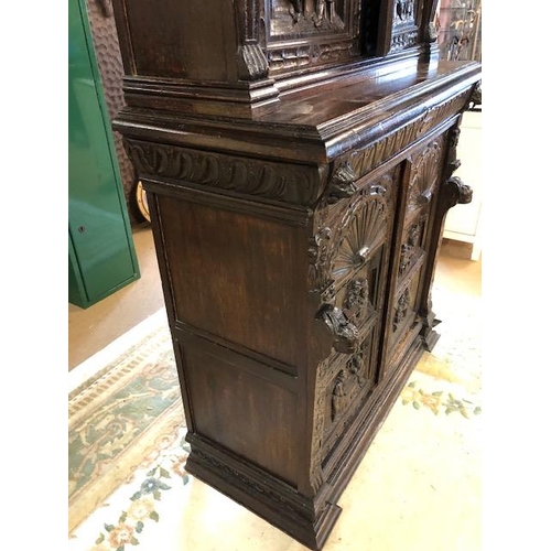 318 - Dresser: late 19th century dark oak continental buffet cupboard, having extensive pictorial carved d... 