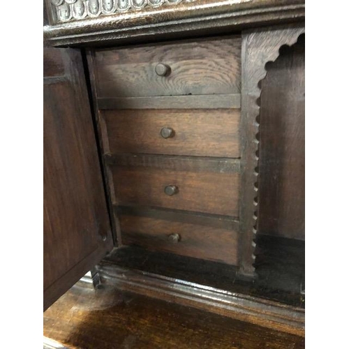 318 - Dresser: late 19th century dark oak continental buffet cupboard, having extensive pictorial carved d... 