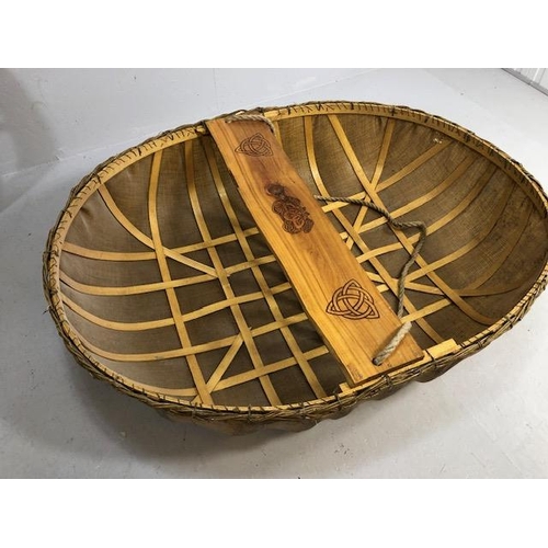 321 - Coracle boat made by Flaxland using wood, woven flax and natural resins, the seat carved with Irish ... 