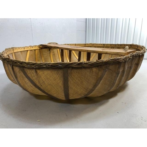 321 - Coracle boat made by Flaxland using wood, woven flax and natural resins, the seat carved with Irish ... 