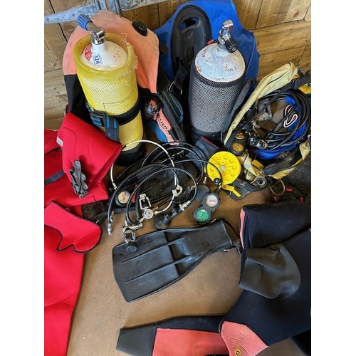 324 - Collection of Suba diving equipment to include SCUBA tanks/ cylinders, Dry Suits, Regulators, weight... 