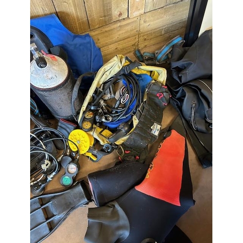 324 - Collection of Suba diving equipment to include SCUBA tanks/ cylinders, Dry Suits, Regulators, weight... 