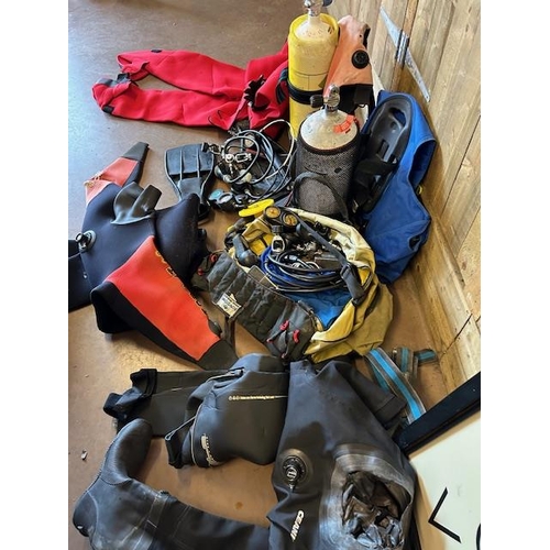 324 - Collection of Suba diving equipment to include SCUBA tanks/ cylinders, Dry Suits, Regulators, weight... 