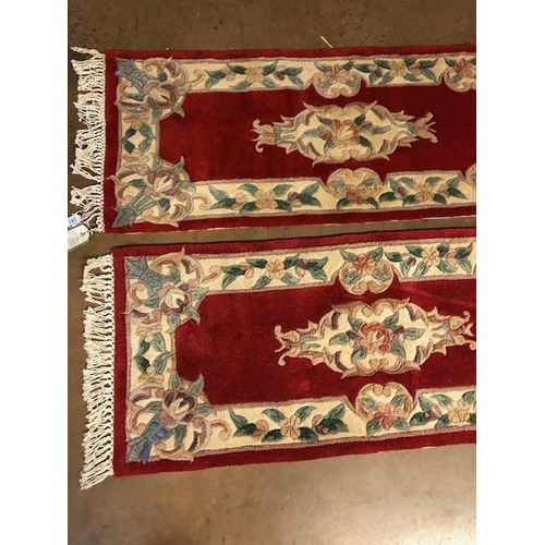 351 - Chinese wool rugs, Two sculpted hall runners with typical designs of flowers against red back ground... 