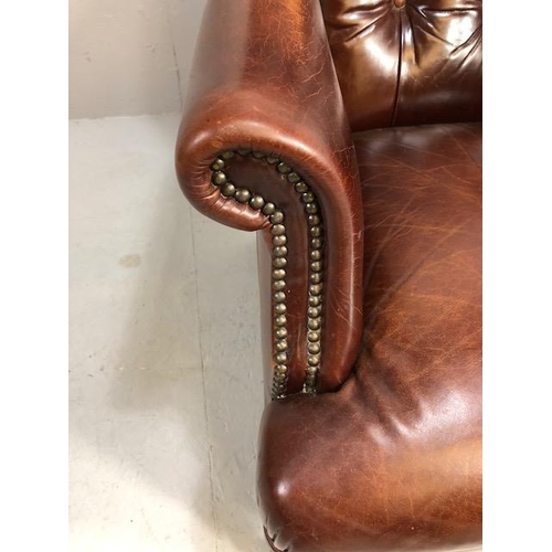 355 - Burgundy leather button back fireside chair with stud detailing and turned front legs