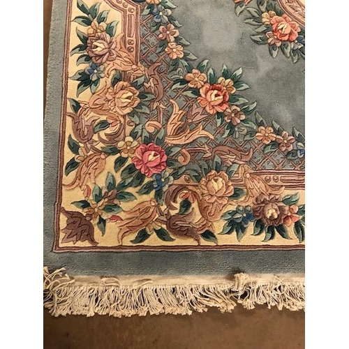 358 - Chinese wool rug of sculpted style with typical designs of flowers and trellis  against a blue grey ... 