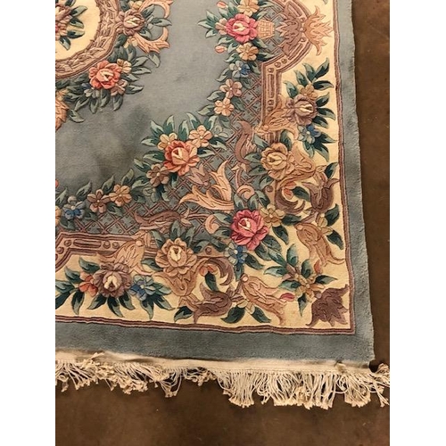 358 - Chinese wool rug of sculpted style with typical designs of flowers and trellis  against a blue grey ... 