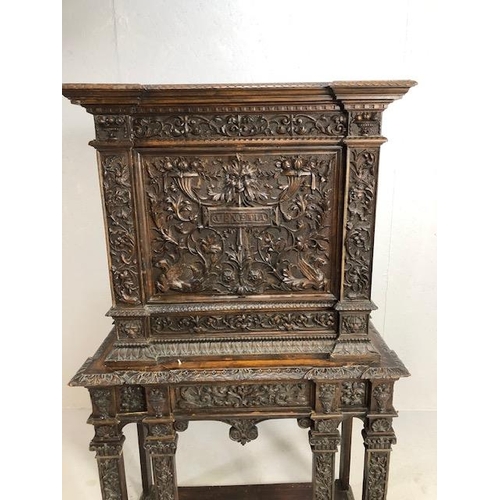 366 - Heavily carved square cupboard on stand, carved with inscription 