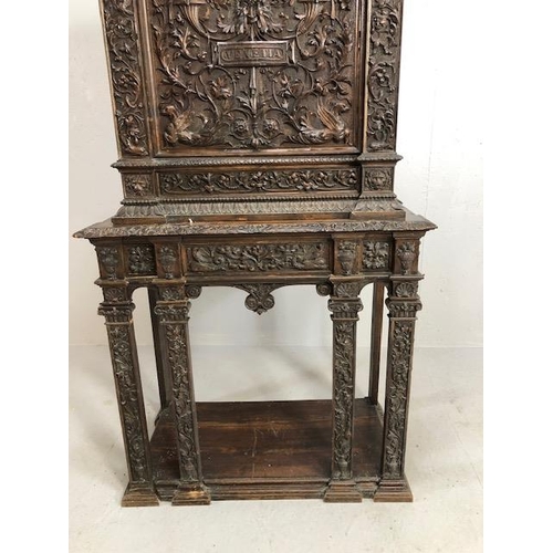 366 - Heavily carved square cupboard on stand, carved with inscription 