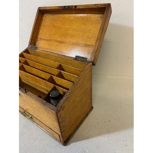 403 - Antique oak slope top writing box with stationary and ink compartments internal bar lock for draw ap... 