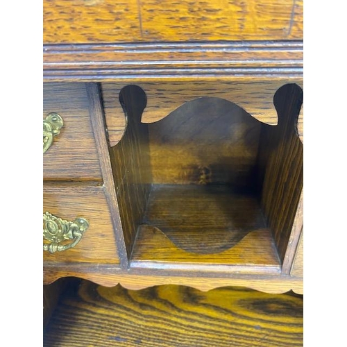 413 - Antique Smokers cabinet, in light oak, part glazed doors opening to show drawers and pipe rack  appr... 