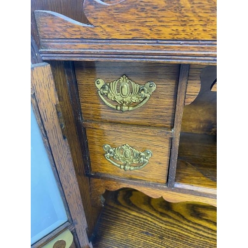 413 - Antique Smokers cabinet, in light oak, part glazed doors opening to show drawers and pipe rack  appr... 