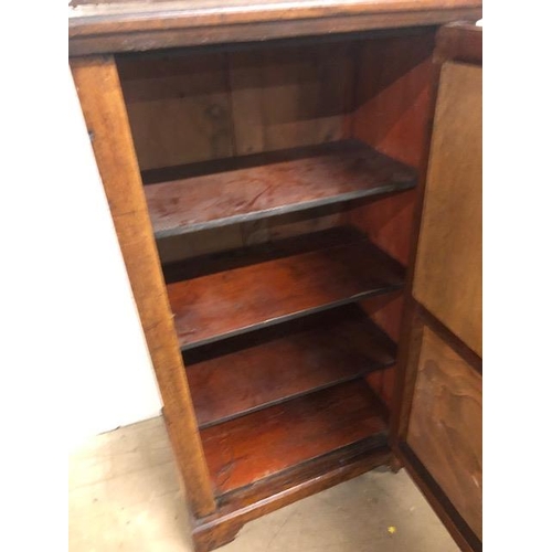 414 - Oak cupboard with bevelled glass inserts and carved panel, opening to three shelves, with original k... 