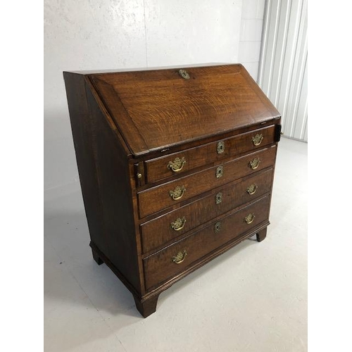 415 - Antique Furniture, late Georgian period oak bureau on bracket feet, run of four drawers with brass h... 