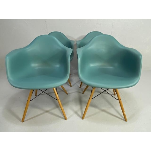 418 - Vitra Eames plastic armchairs, design Charles and Ray Eames, set of four with outsplayed wooden legs... 