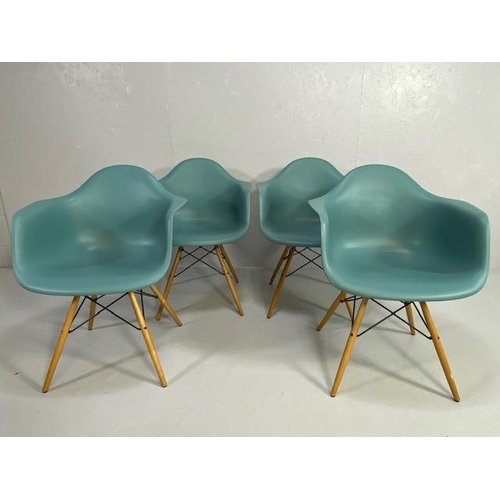 418 - Vitra Eames plastic armchairs, design Charles and Ray Eames, set of four with outsplayed wooden legs... 