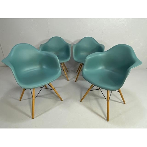 418 - Vitra Eames plastic armchairs, design Charles and Ray Eames, set of four with outsplayed wooden legs... 