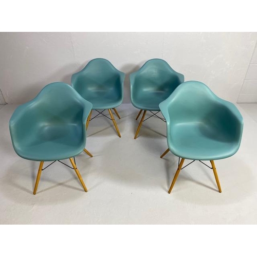 418 - Vitra Eames plastic armchairs, design Charles and Ray Eames, set of four with outsplayed wooden legs... 