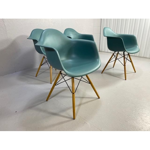 418 - Vitra Eames plastic armchairs, design Charles and Ray Eames, set of four with outsplayed wooden legs... 