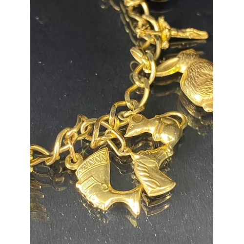 42 - 9Ct Gold charm bracelet with a collection of 9ct gold charms, to include, rabbit, Dolphins, Boot, Mo... 