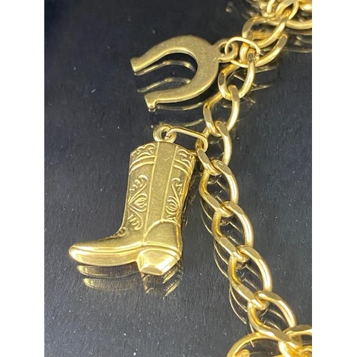 42 - 9Ct Gold charm bracelet with a collection of 9ct gold charms, to include, rabbit, Dolphins, Boot, Mo... 